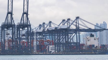 Industrial port with containers ship in the Victoria Harbor at Hong Kong city