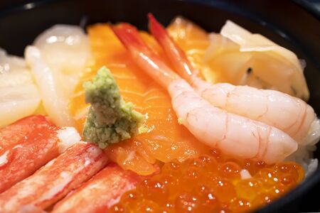 Selective focus of mix sashimi (salmon, crab, shrimp, scallop) in rice bowl, mix sushi donburi in...