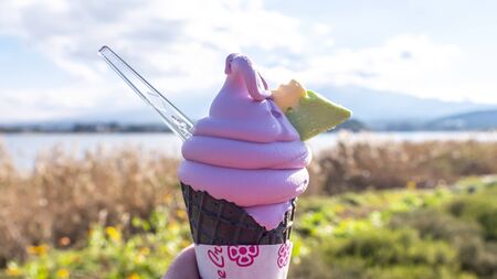Woman hold blueberry soft cream at Kawaguchiko Natural Living Center, Yamanashi, Japanの写真素材