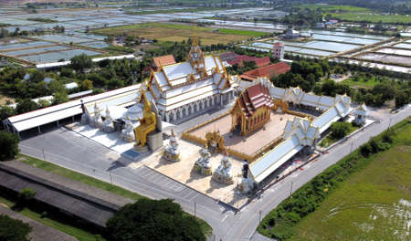 Aerial view - Big Buddha Statue and the temple in blue sky far view at Wat Charoen Rat Bamrung Wat Nong Pong Nok - Nakhon Pathom Province, Thailand.の写真素材