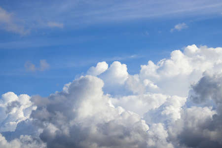 White cloudy with little grey in clear blue sky. That later will have rain.