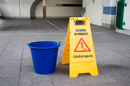 Cleaning in progress sign with bucket of water, With Thai character saying "cleaning in progress".の写真素材
