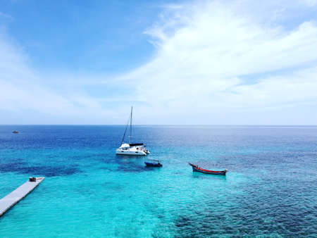 Aerial view of coast beach, yacht ship, beach buoy, green blue sea - Koh Hey island, Phuket province, Thailand.の写真素材
