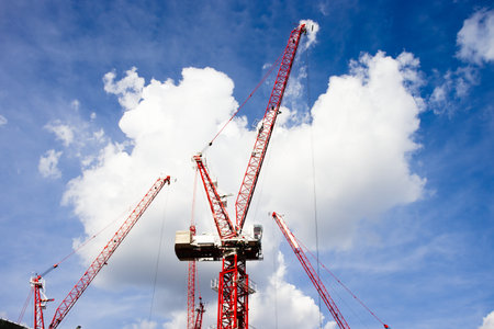 Tower crane at construction site with blue sky background. Day time.の写真素材