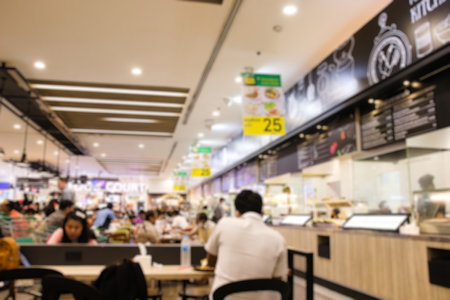 Blurred of Food court in department store. Many people having meal and line of food stores.の写真素材