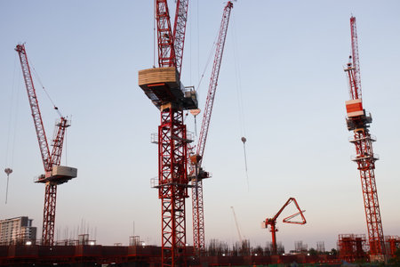 Bangkok, Thailand - December 9, 2020 : Tower crane at construction site with sky sunset background.のeditorial素材