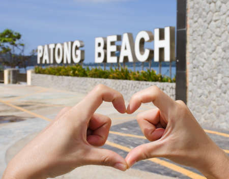 Patong Beach Sign landmark of Patong Beach at Phuket, Thailand. With finger heart concept: travel destination.の写真素材