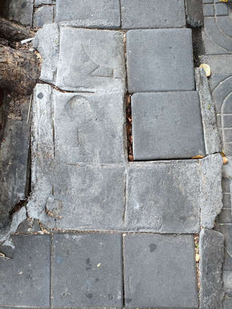 Broken sidewalk brick block in urban. Risk, danger for pedestrians. Concept city life.の写真素材