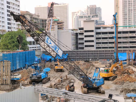 Bangkok, Thailand - March 16, 2021 : Construction site and heavy machinery - high angle view. Dig for reinforcement. Concept safety in work, development, investment.のeditorial素材