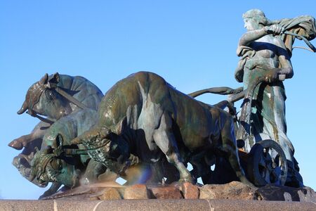 Gefion Fountain in Copenhagen, with rainbow over the nose of bullの写真素材