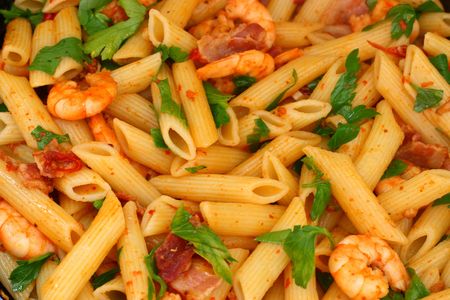 Chili shrimps with vine, pasta, bacon, garlic, spices and lemon grassの写真素材