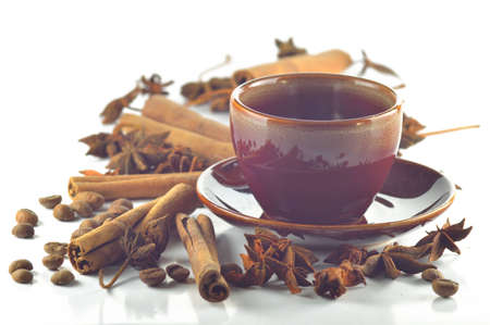 Cinnamon, anise and coffee beans with a cup of coffeeの写真素材
