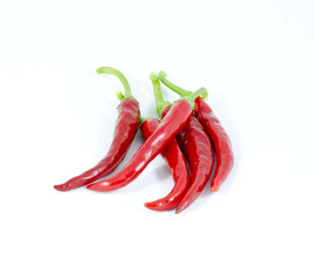 A pile of fresh red chili peppers isolated on a clean white background