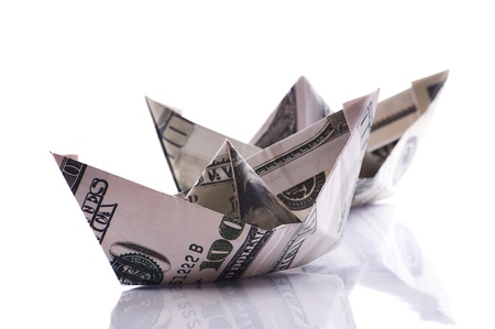 paper boats from dollars banknote on whiteの写真素材