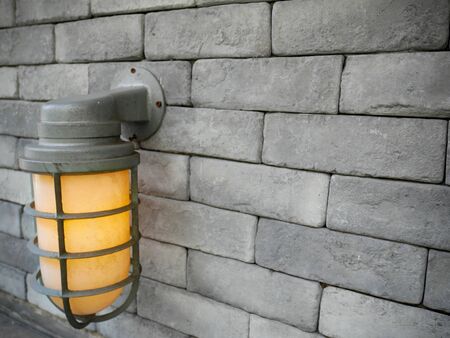 The lantern on the vintage brick wall. Background of old vintage wall.の写真素材