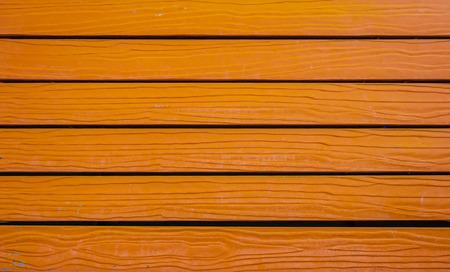 Texture of orange color stripe wooden lumber wall. Bright color use for background.の写真素材
