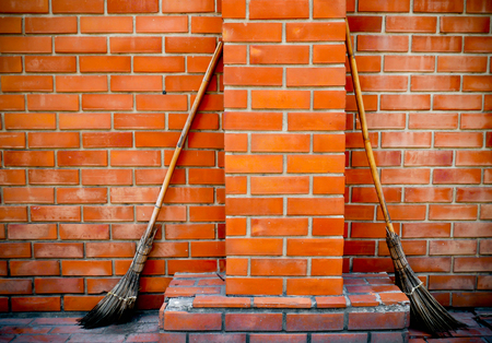 Broom on brick wall Surface of the wall pattern. Can be used for background for cleaning floor dust  concept.の写真素材