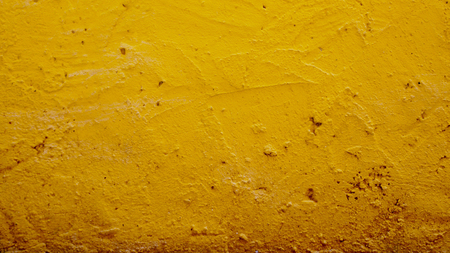 Concrete wall yellow color paint for texture backgroundの写真素材
