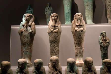 Leiden, The Netherlands JAN 26, 2019: small ancient stone shabti mummiform figurines at the exhibition Gods of Egypt in Leiden. Funerary figurines.のeditorial素材