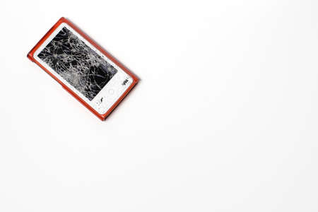 An MP3 player with a broken glass screen. Damaged glass.