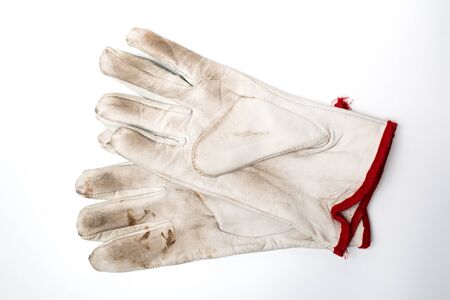 A pair of used leather work gloves on a white background. Personal safety equipment.