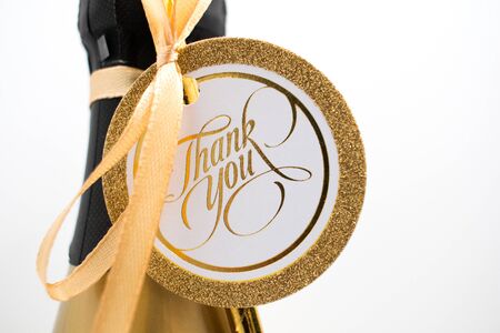 Closeup of a champaign bottle with a card saying Thank You.の写真素材