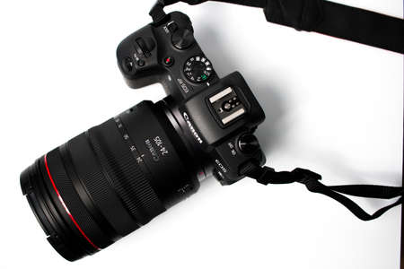 Schiedam, The Netherlands - NOV 23, 2019: top view of the new Canon EOS RP full frame mirrorless camera with the new RF 24-105 mm lens on a white background.のeditorial素材
