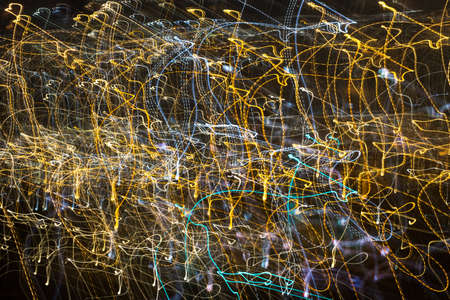Abstract image of colorful dancing lights on a dark background. Lines and swirls.の写真素材