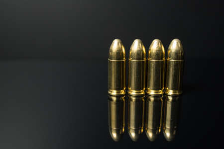 Closeup of a row of 9 mm pistol bullets. Gun ammunition.の写真素材