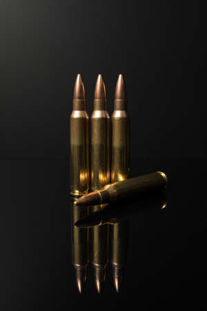 A row of caliber .223 5.56x45 rifle bullets. Automatic rifle ammo.