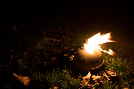 a burning oil lamp burning at night. The flames are dancing on the sound of the wind.
