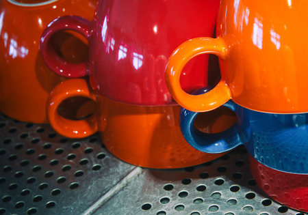colorful cups stacked on the heated surface of the coffeeの写真素材