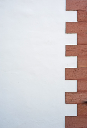 old building wall with regular brick pattern on one sideの写真素材