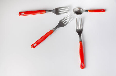 tea spoon surrounded by forks