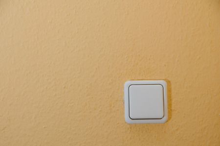 light switch on a textured wallの写真素材