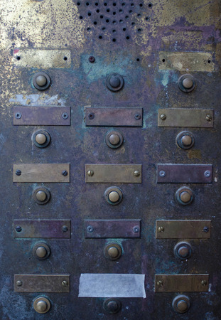retro grungy apartment doorbell buzzer intercom with empty name plates