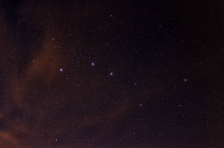Stars of the Big Dipper, part of  constellation Ursa Major, shining through the clouds illuminated...