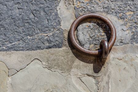 symbolic metal mooring ring on a stone ground of the wharfの写真素材