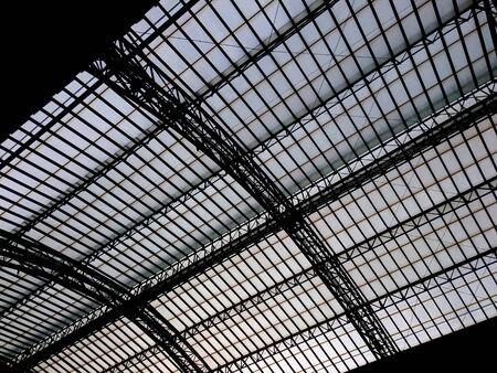 silhouette of glass and metal industrial ceiling creating an abstract background
