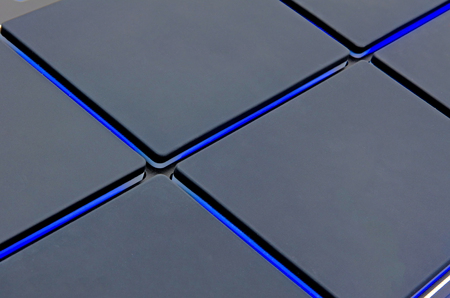 high tech background of pads surrounded by glowing blue lightの写真素材