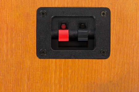 black and red knobs for electric cables in a wooden casingの写真素材