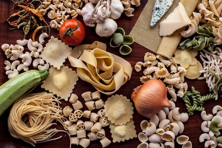 Italian pasta collection on rustic wooden tableの写真素材