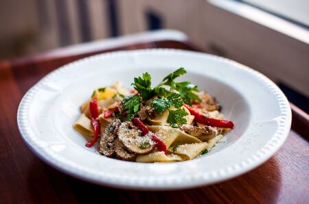 Special Italian Pasta with vegetables mushroom, parsley, red paper and parmesanの写真素材