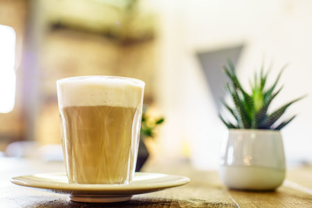 Coffee Latte on the wooden table in UKの写真素材