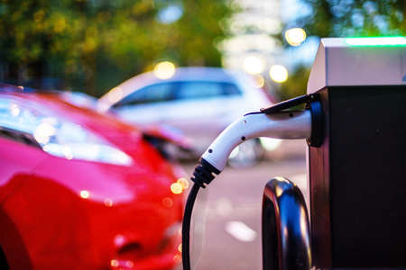 Electric Vehicle is changing in street.の写真素材