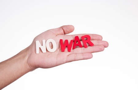 On hand with wood letters written "No war"の写真素材