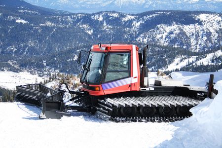 A photo of a snowplow on top of a mountainの写真素材