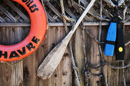 Life preserver, oar, and nettingの写真素材