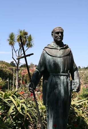 Priest statue in the garden with dramatic shadowsの写真素材