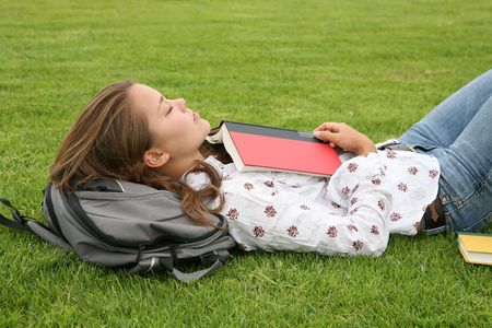 A young woman sleeping after reading a bookの写真素材